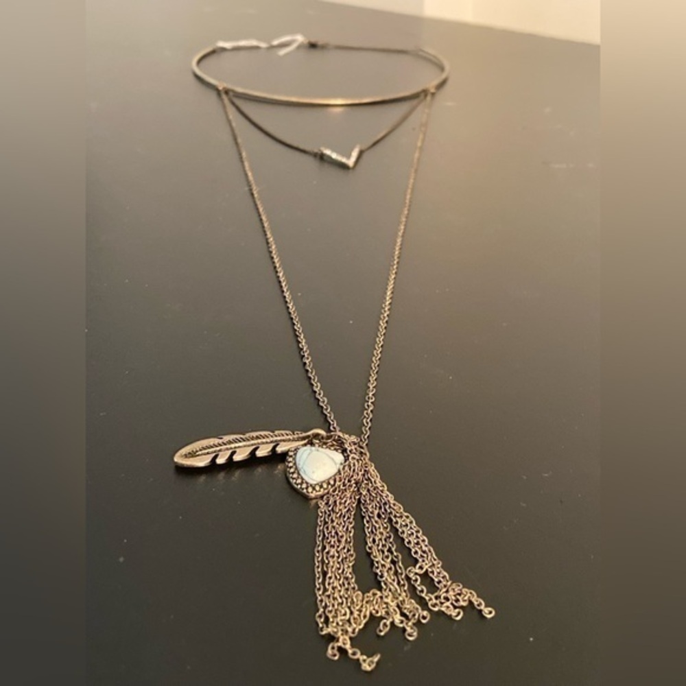 Very long golden necklace with feather and stone and tassel pendant. 15”